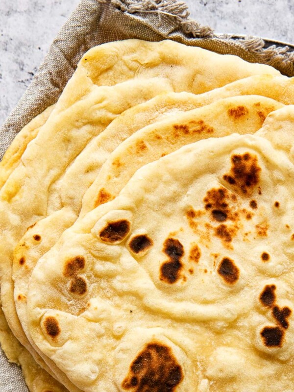 stacked flatbread on grey cloth napkin