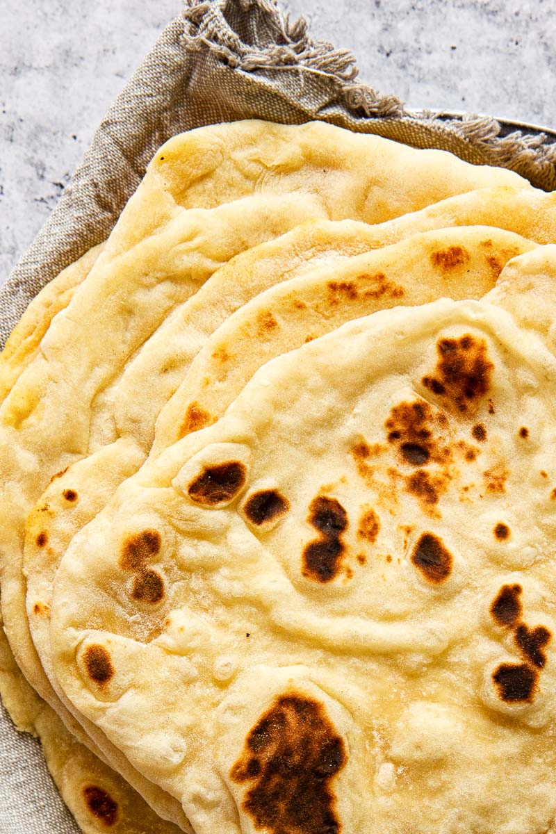 stacked flatbread on grey cloth napkin