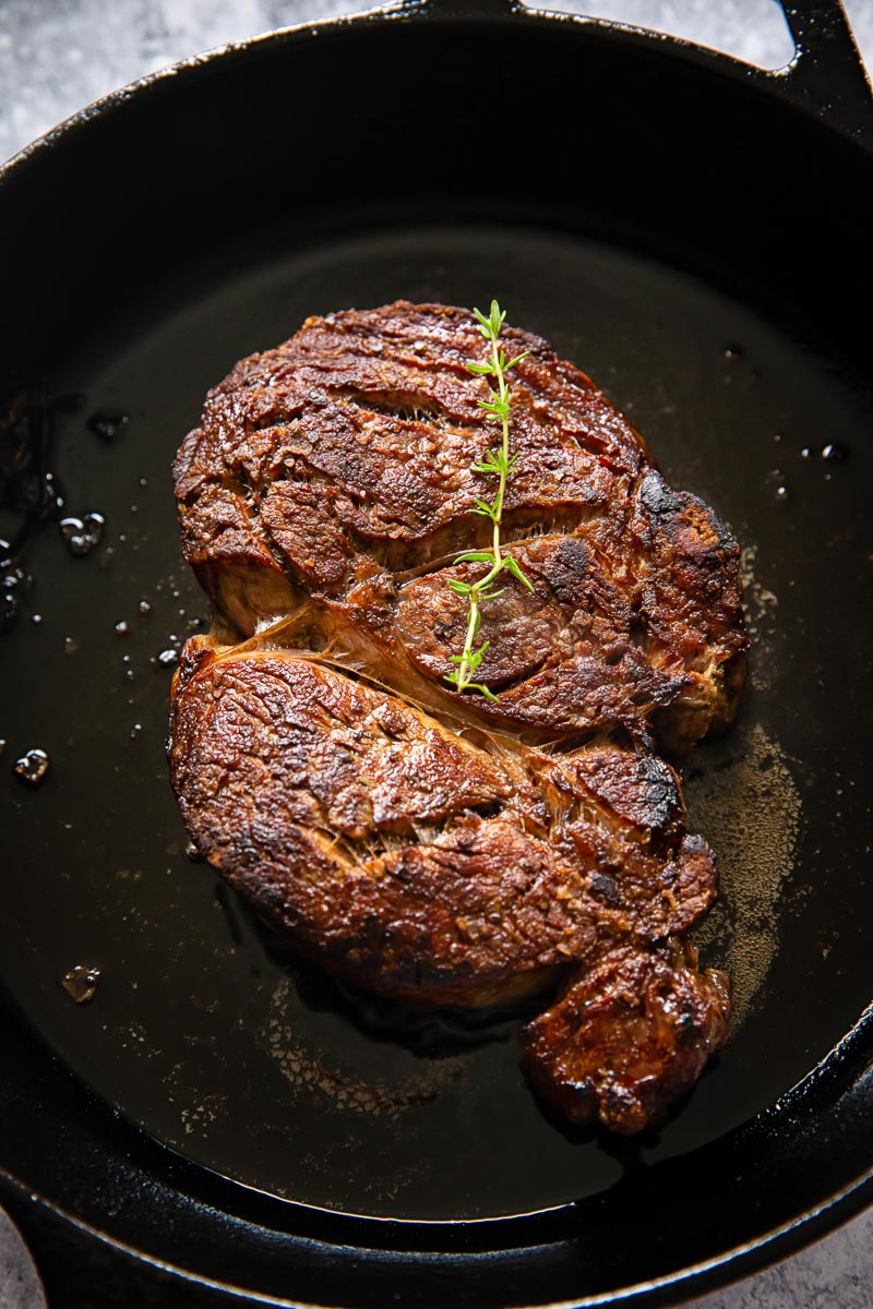 cooked ribeye on cast iron pan