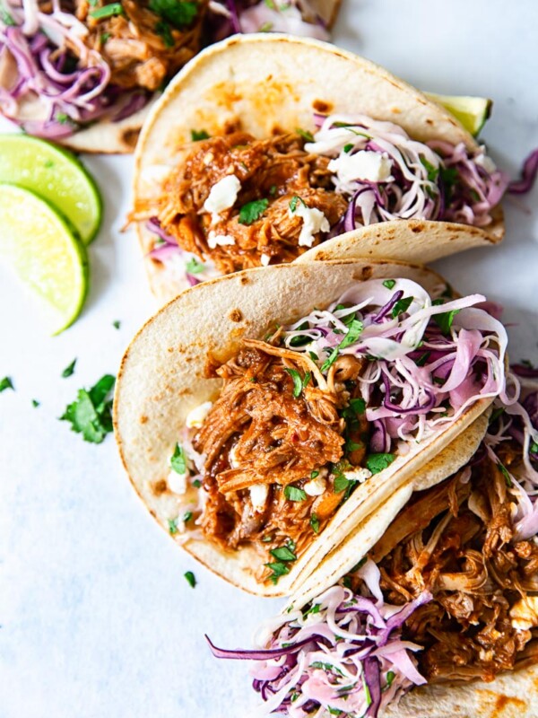 soft corn tacos filled with pulled pork and slaw