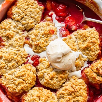 plum cobbler with a scoop of vanilla ice cream on top