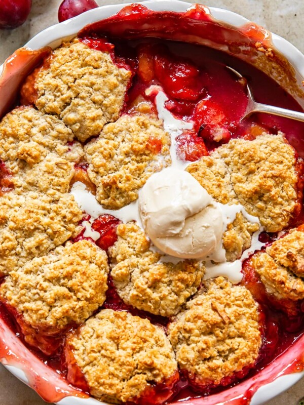 plum cobbler with a scoop of vanilla ice cream on top