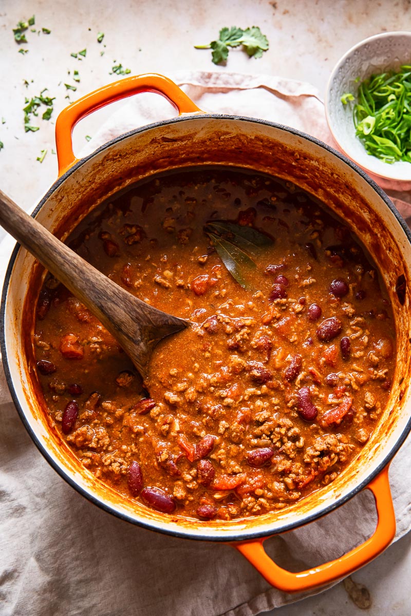 top down view of beef and kidney bean chilli con carne in orange pot