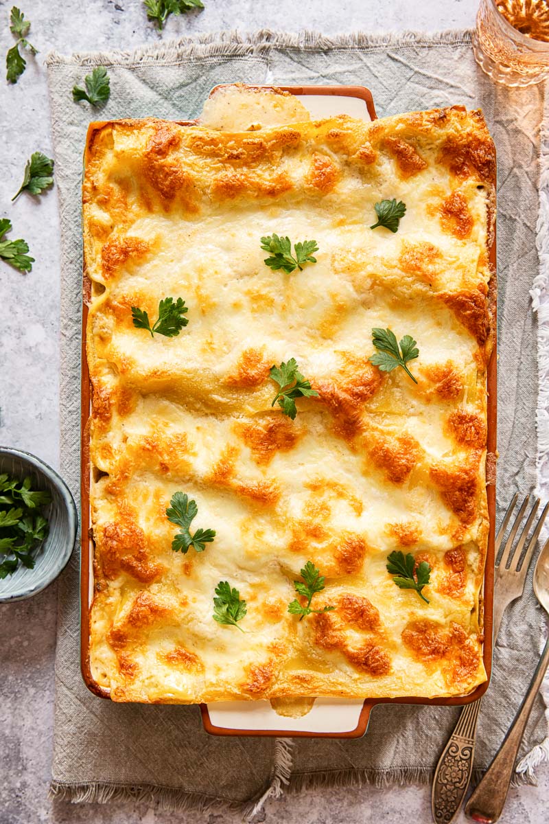 top down view of seafood lasagna topped with parsley leaves