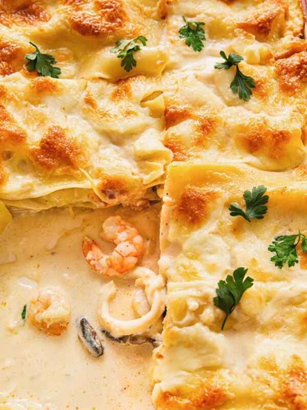 close up image of seafood lasagna with white sauce