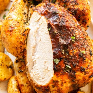roast chicken with slice removed to show white meat