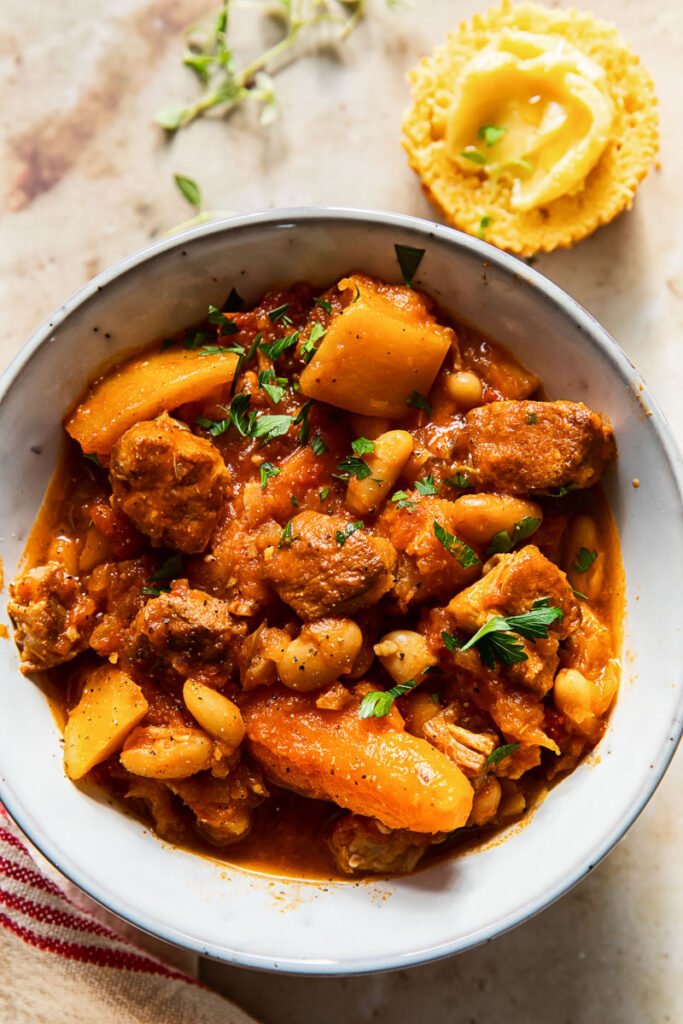 pork stew with carrots and butternut squash in grey bowl