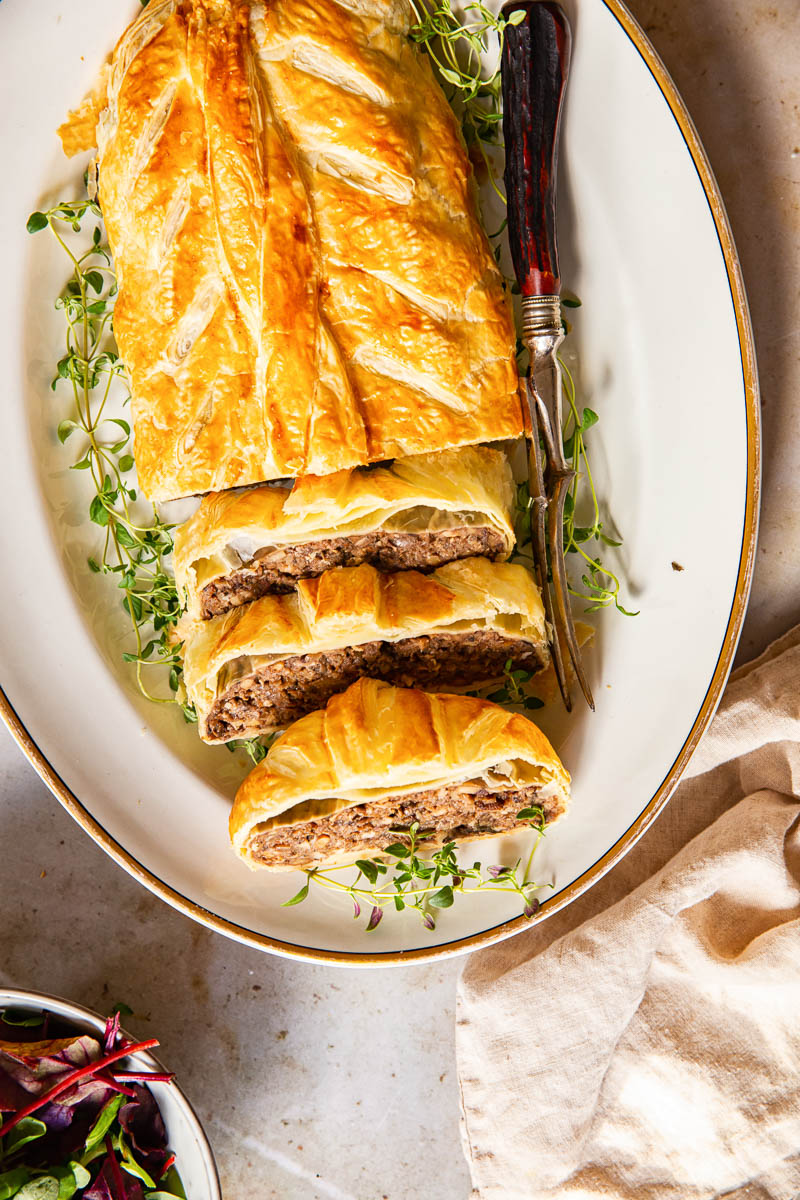 top down view of sliced Mushroom Wellington on while platter