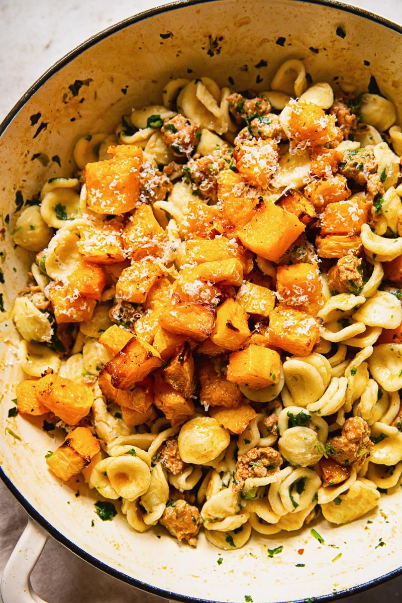 butternut squash on top of orecchiette pasta with sausage and spinach