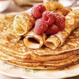 close up of blini with raspberries