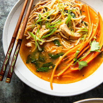 Chicken noodle soup in bowl with chopsticks