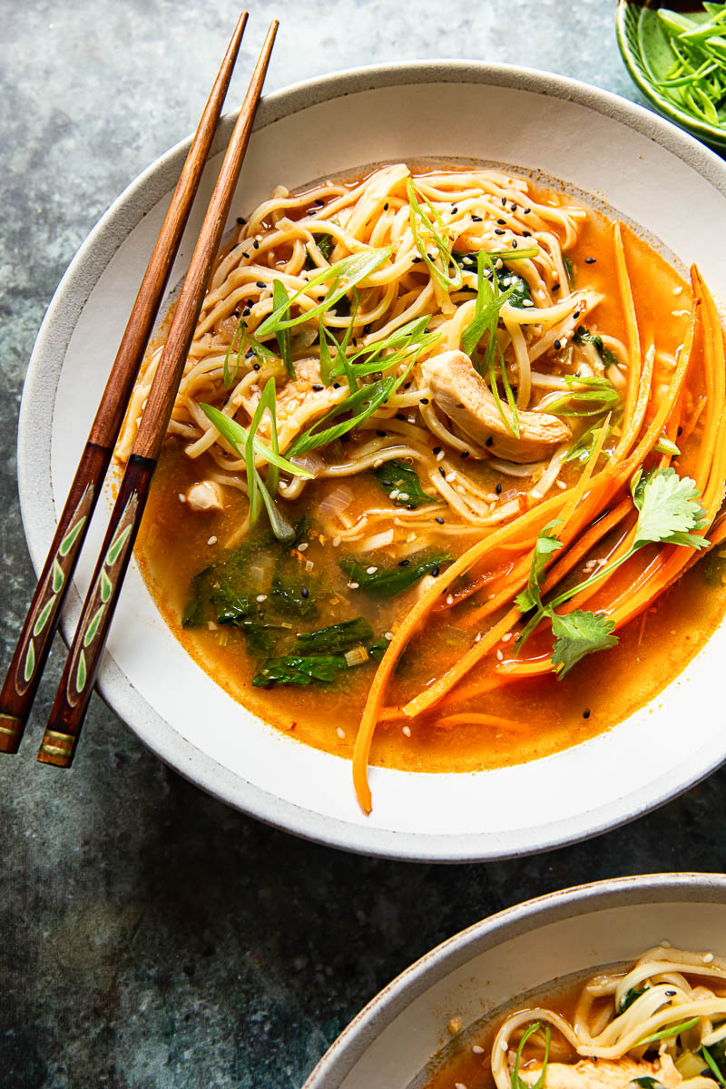 Chicken noodle soup in bowl with chopsticks