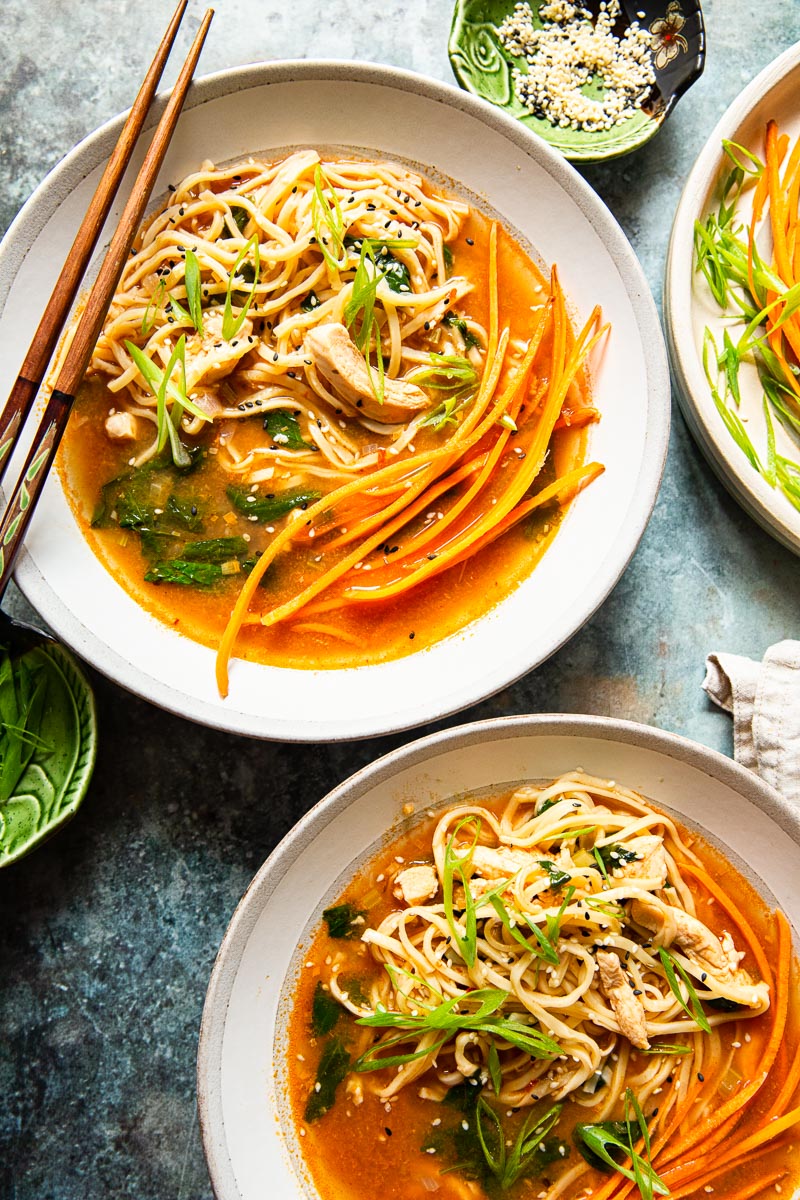 top down view of two bowls of Thai noodle soup