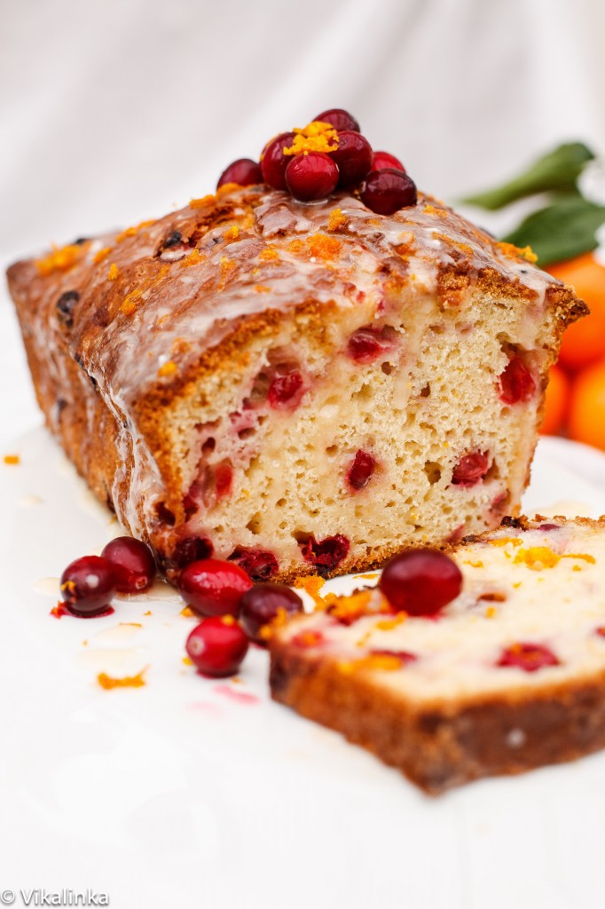 cranberry bread with orange glaze, one slice cut off the loaf