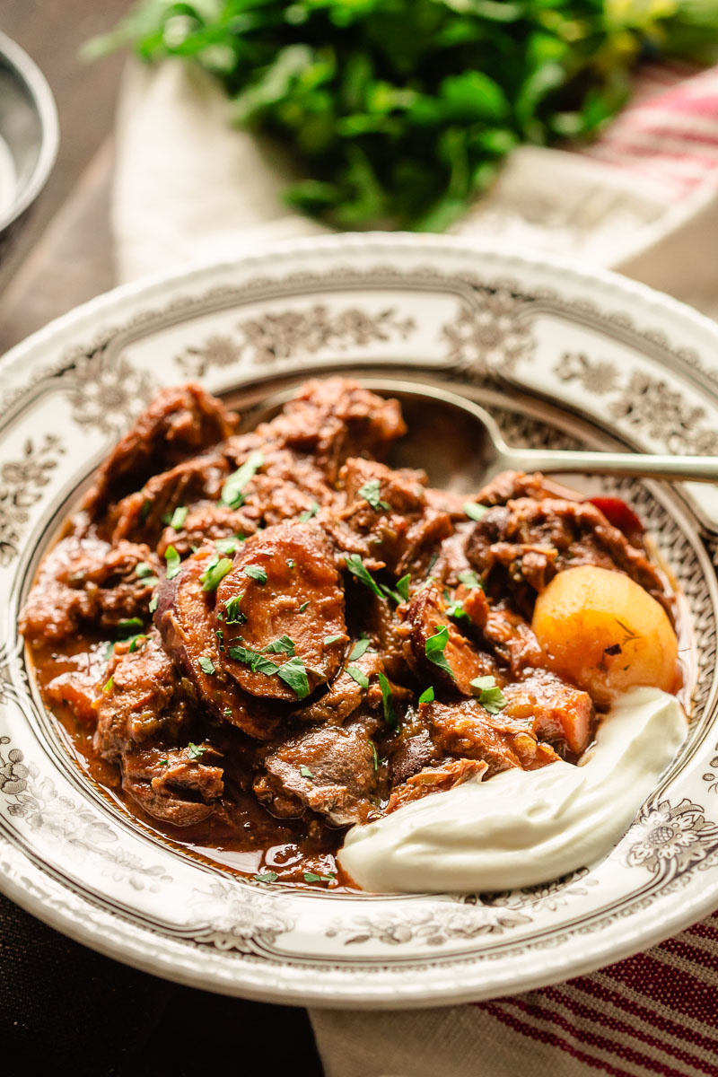 beef stew in a bow with a dollop of sour cream