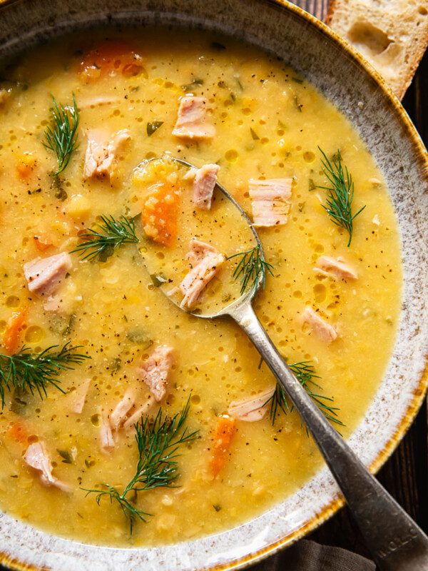 top down view split pea and ham soup in a bowl with a spoon in it