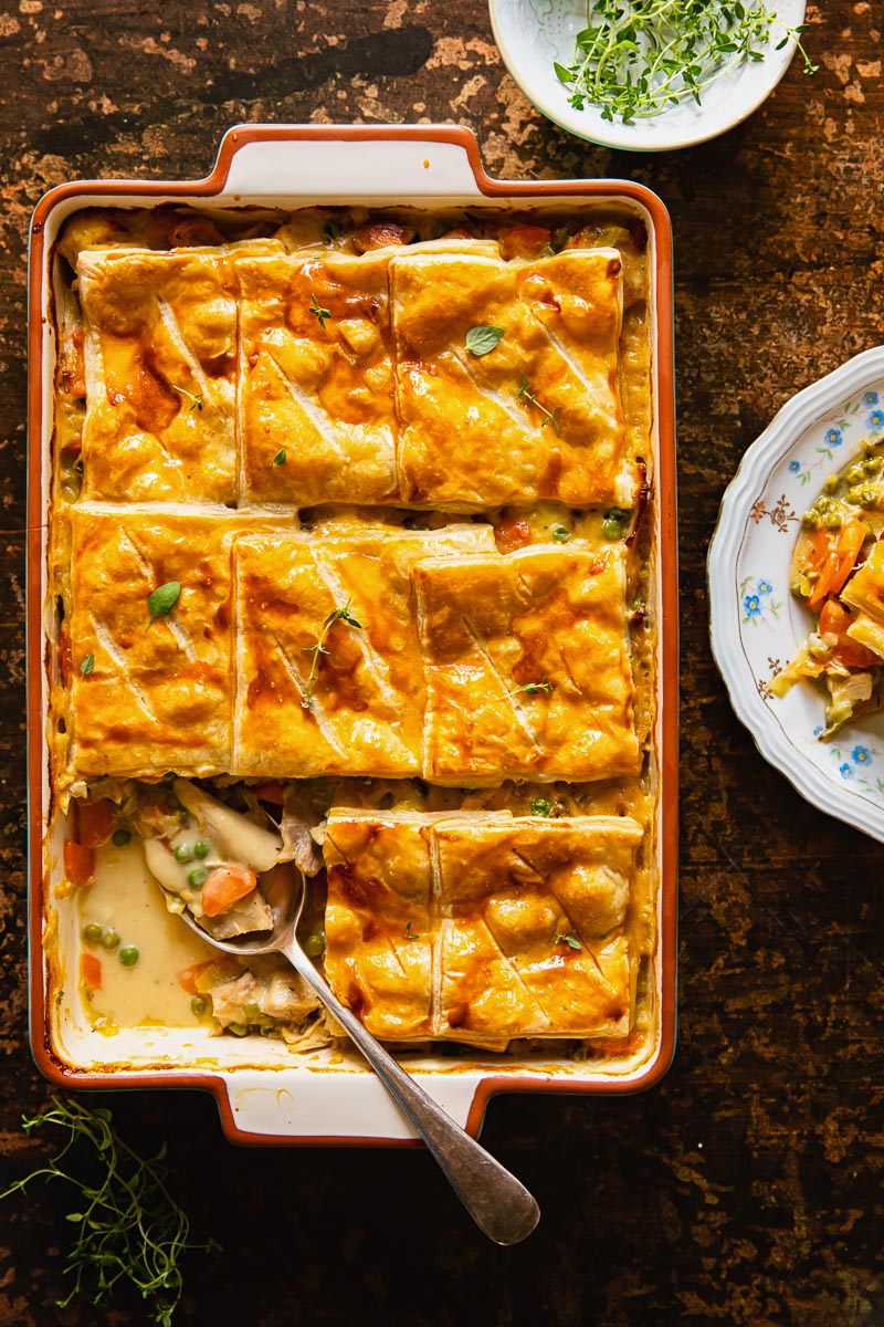 top down view of the pot pie with puff pastry on brown background