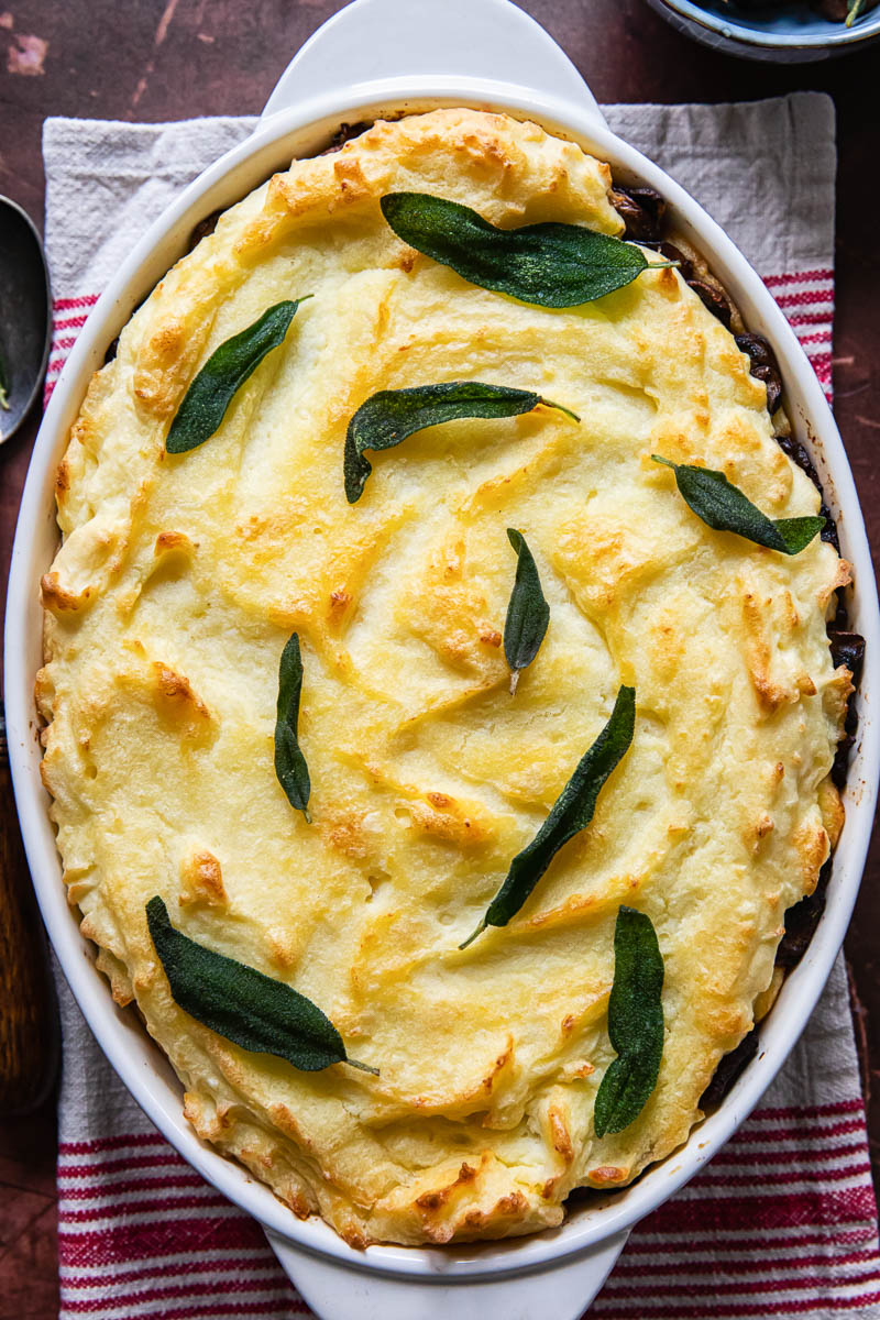 mashed potato casserole topped with fried sage leaves