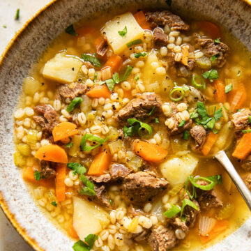 Beef Barley Soup sprinkled with herbs and green onions