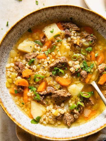 Beef Barley Soup sprinkled with herbs and green onions