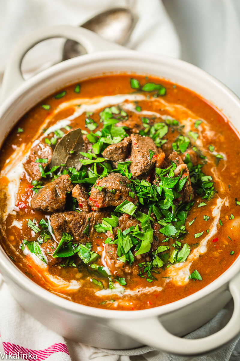 top down view of beef stew sprinkled in with chopped parsley