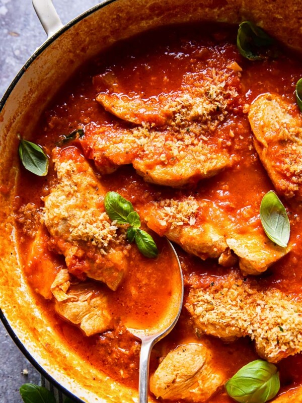 chicken in tomato sauce topped with fresh basil and breadcrumbs