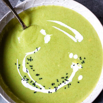 top down view of cream of broccoli soup in grey bowl