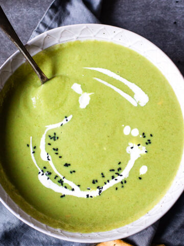 top down view of cream of broccoli soup in grey bowl