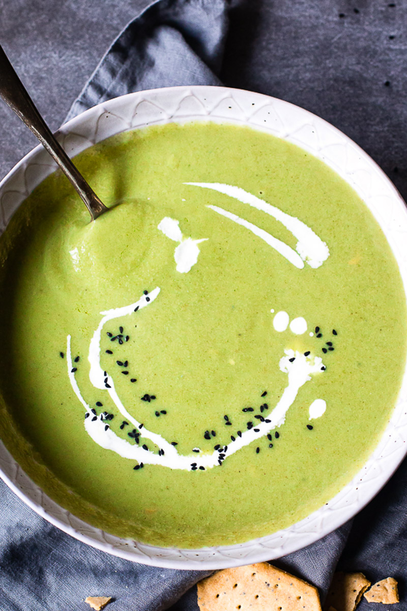 top down view of cream of broccoli soup in grey bowl