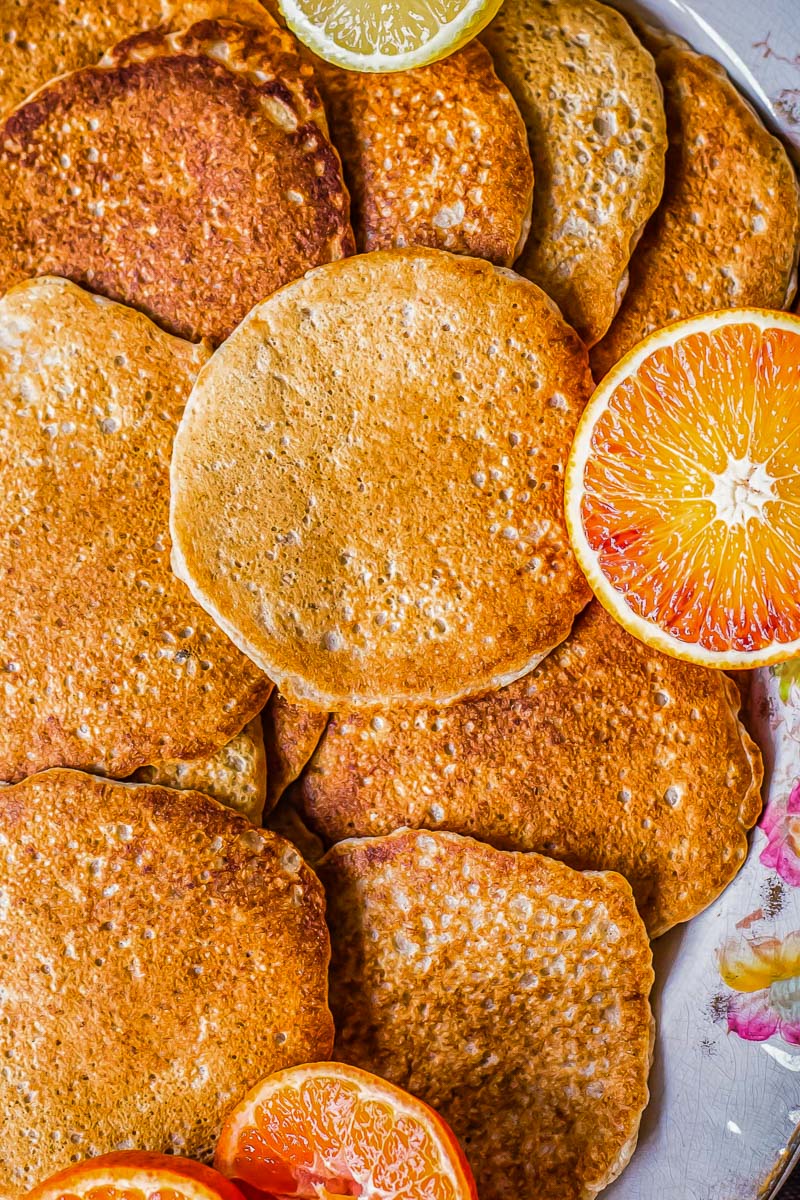 pancakes and sliced blood oranges on a platter 