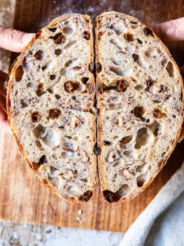 walnut and raisin bread cut in halh