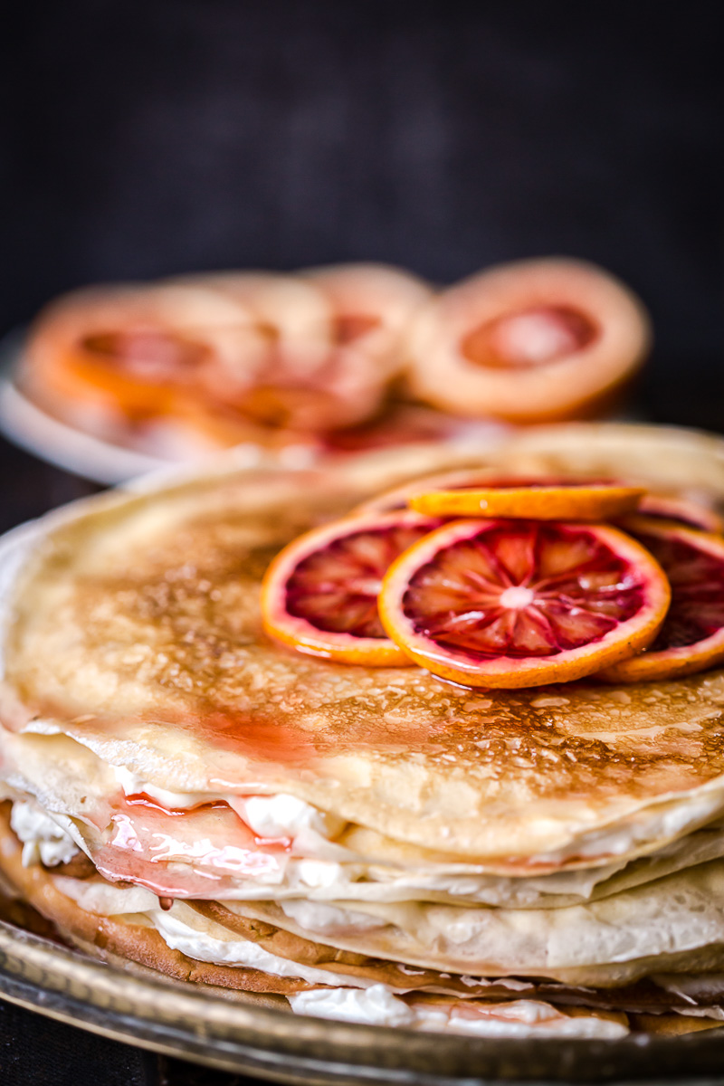 crepe cake topped with sliced blood oranges