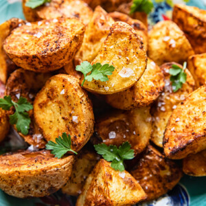 top down view of roast potatoes sprinkled with flaky salt and parsley