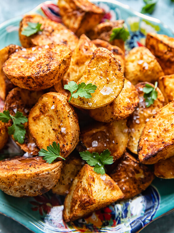 top down view of roast potatoes sprinkled with flaky salt and parsley