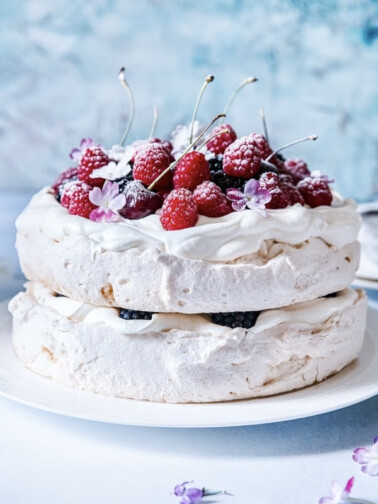 double stacked berry pavolva on a plate