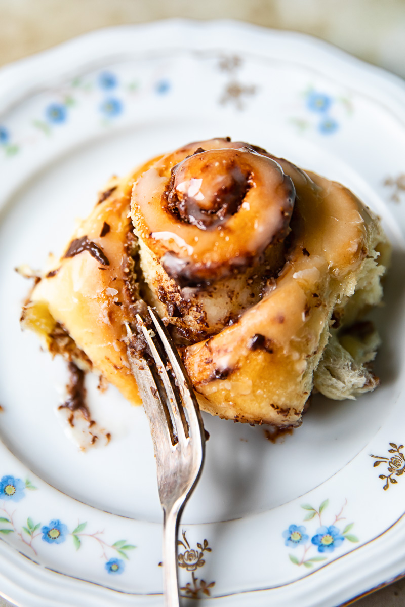 chocolate roll on a plate with a fork in it