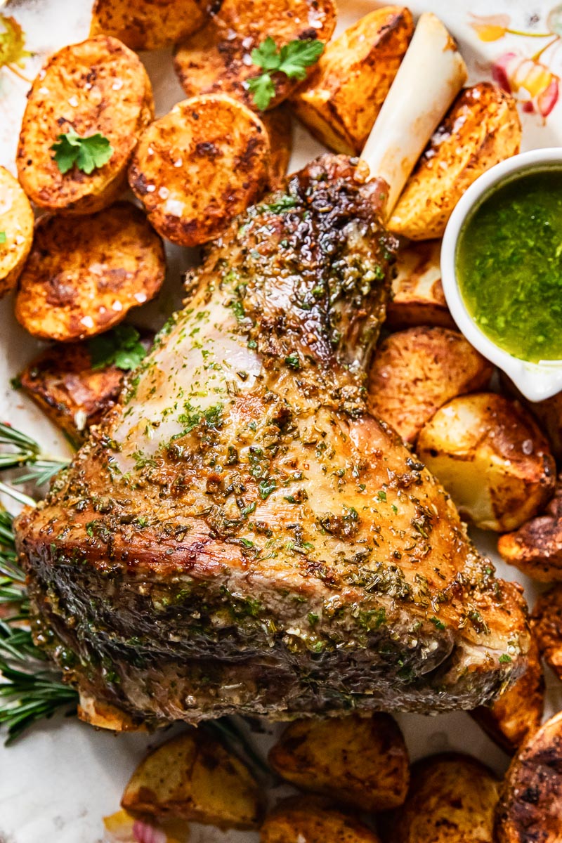 top down view on a platter with mint sauce and roast potatoes