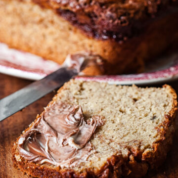 a slice of banana bread spread with nutella.