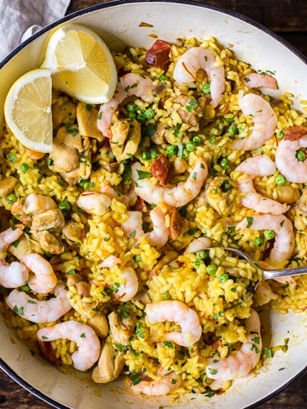 top down view of yellow Spanish rice with chicken, shrimp and lemon slices