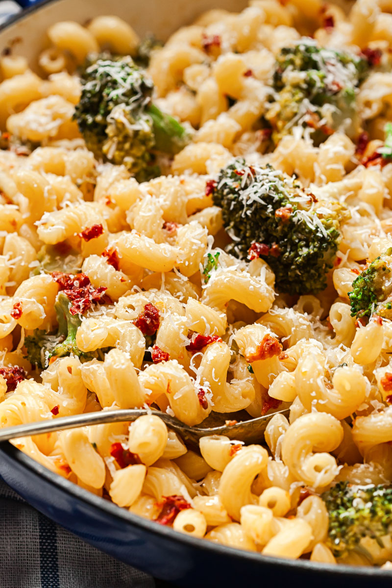 pasta with broccoli and sun-dried tomatoes in a pan