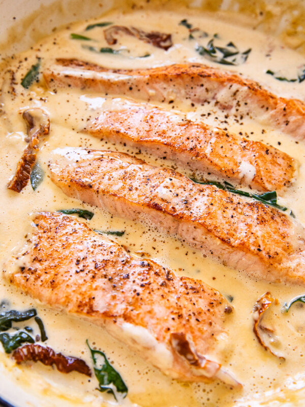 salmon in cream sauce with sun-dried tomatoes and spinach