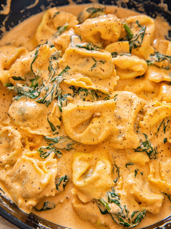 tortellini in creamy sauce in cast iron pan