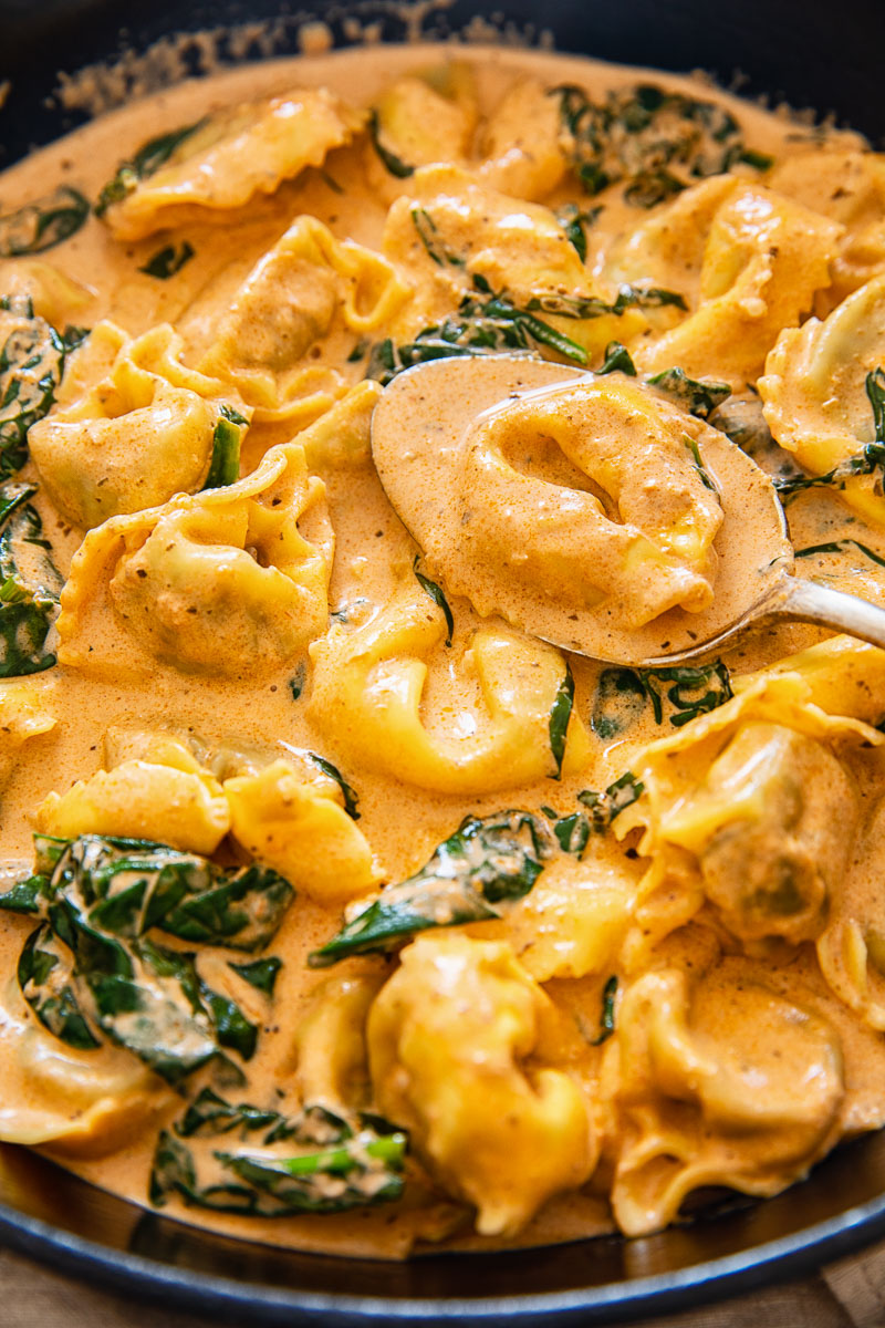 tortelloni in a creamy tomato sauce with spinach