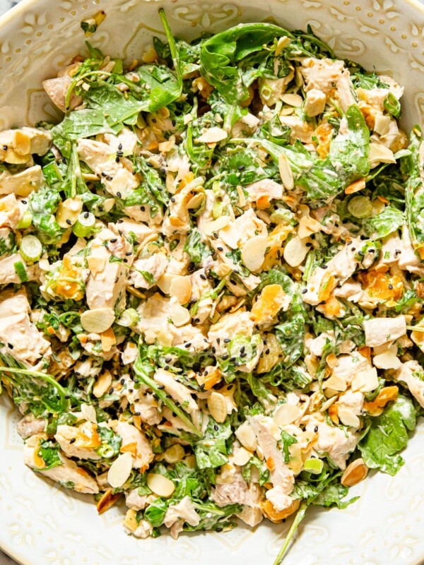 chicken salad with arugula, almonds and apricots in a bowl