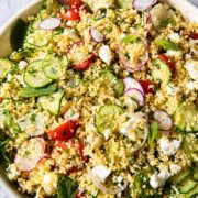 top down view of couscous salad with vegetables and feta