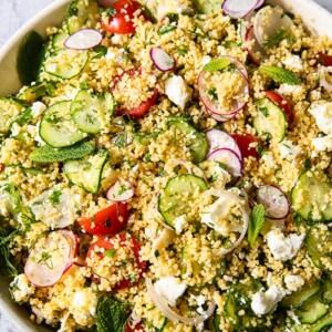 top down view of couscous salad with vegetables and feta