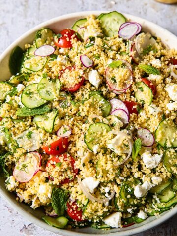 top down view of couscous salad with vegetables and feta