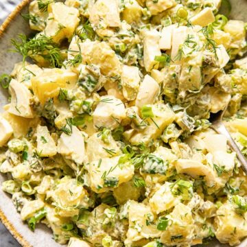 top down view of potato salad with dill and green onions