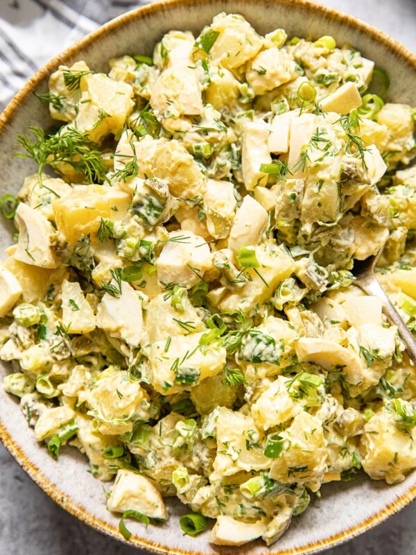 top down view of potato salad with dill and green onions