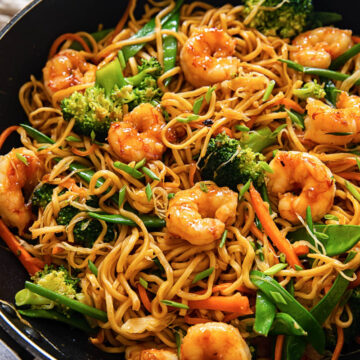 top down view of shrimp with stir fried noodles and vegetables